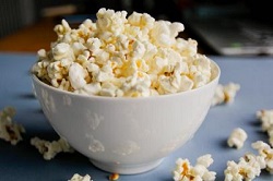 White bowl filled with protein popcorn for a healthy popcorn snack.