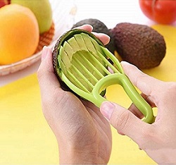 A pair of hands using the 4-in-1 avocado peeler representing time saving kitchen gadgets for busy families.