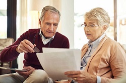 Image of an elderly couple learning the difference between revocable and irrevocable trusts