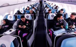Sports team traveling on a plane after using discount travel programs for college and high school sports teams