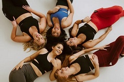 A dance team chilling in their women's dance performance leggings