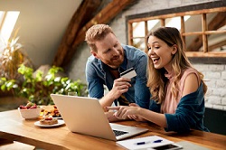Image of a happy and excited couple saving money with Fun Saver Network with spectacular savings