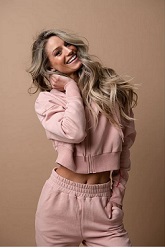 Long blonde haired lady sporting her light pink women's sport apparel outfit