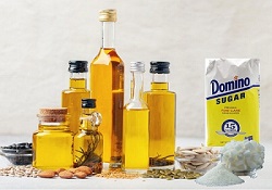 Various seed oils and a bag of sugar indicating to Fix Your Health From Seed Oils and Sugar.